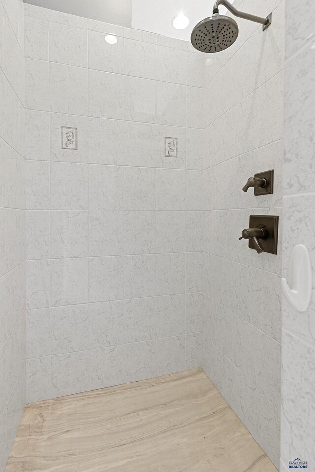 6717 Kennemer Dr, Rapid City, SD 57702 - bathroom with a tile shower and wood finished floors