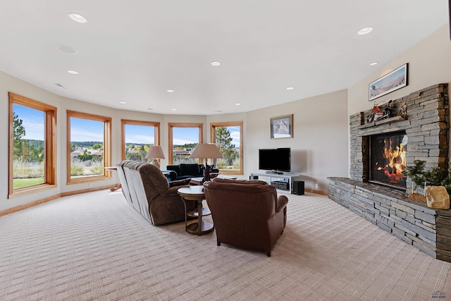 6717 Kennemer Dr, Rapid City, SD 57702 - living room with light carpet, a stone fireplace, recessed lighting, and baseboards