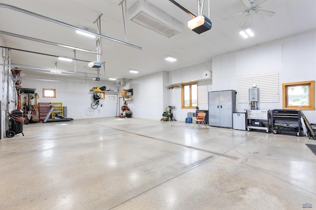6717 Kennemer Dr, Rapid City, SD 57702 - garage with a garage door opener, electric panel, and a ceiling fan
