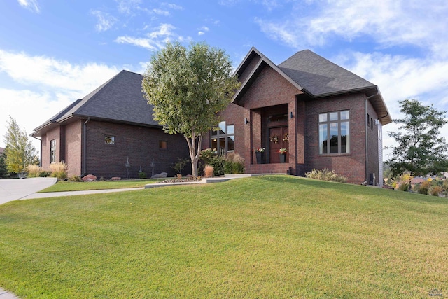 6717 Kennemer Dr, Rapid City, SD 57702 - view of front of home with brick siding, a front lawn, and a shingled roof