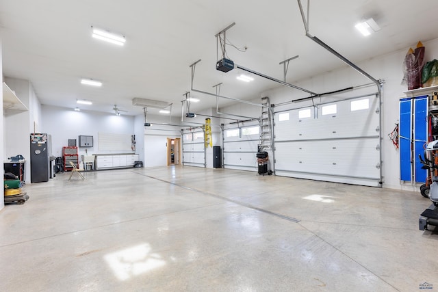 6717 Kennemer Dr, Rapid City, SD 57702 - garage featuring a garage door opener and electric panel