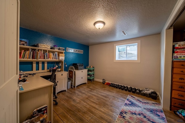 1421 12th Ave, Belle Fourche, SD 57717 - office space featuring a textured ceiling and dark wood-style floors