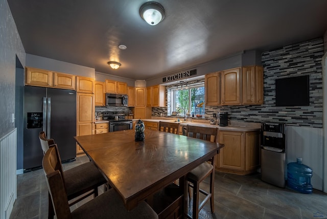 1421 12th Ave, Belle Fourche, SD 57717 - kitchen featuring stainless steel fridge with ice dispenser, electric stove, tasteful backsplash, dark stone finish floors, and light countertops
