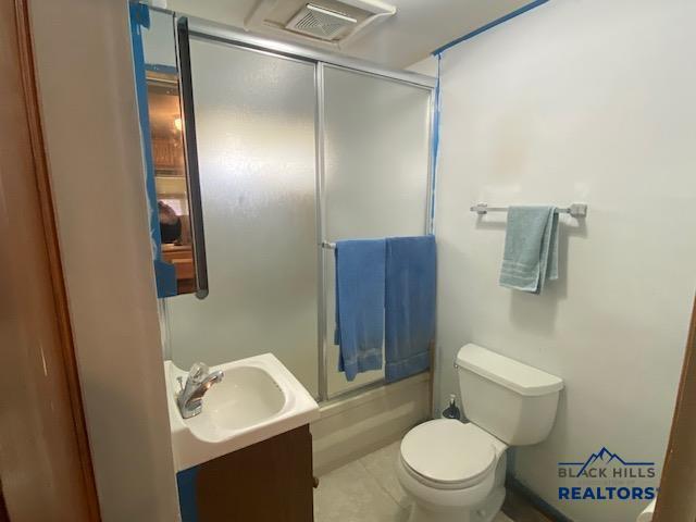 1220 Shephard St, Sturgis, SD 57785 - full bath featuring toilet, vanity, and combined bath / shower with glass door