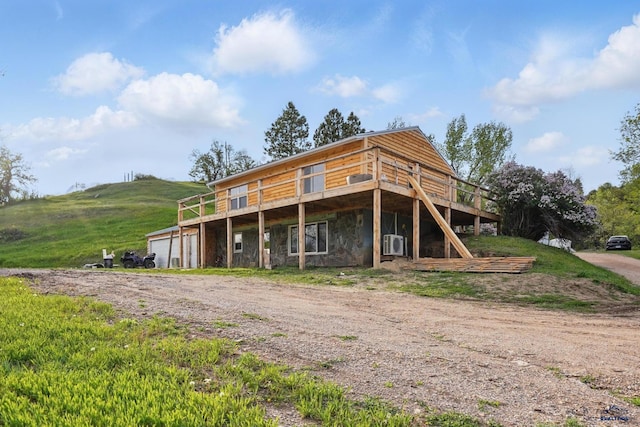 385 15th St, Sturgis, SD 57785 - view of front of house with a deck, a garage, and dirt driveway