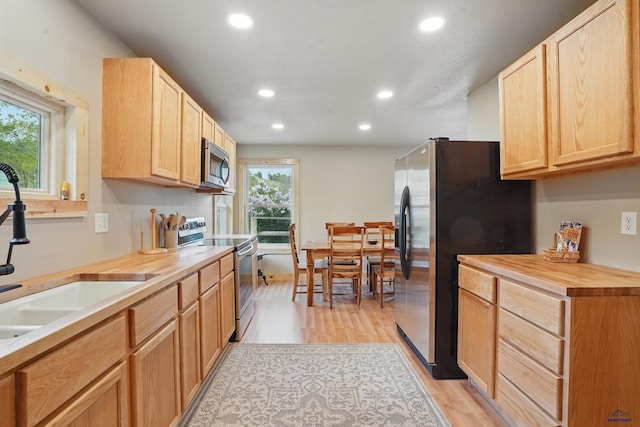 385 15th St, Sturgis, SD 57785 - kitchen with appliances with stainless steel finishes, a sink, light brown cabinetry, recessed lighting, and light wood-style flooring