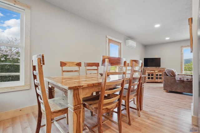 385 15th St, Sturgis, SD 57785 - dining room featuring plenty of natural light, an AC wall unit, light wood-style floors, and recessed lighting