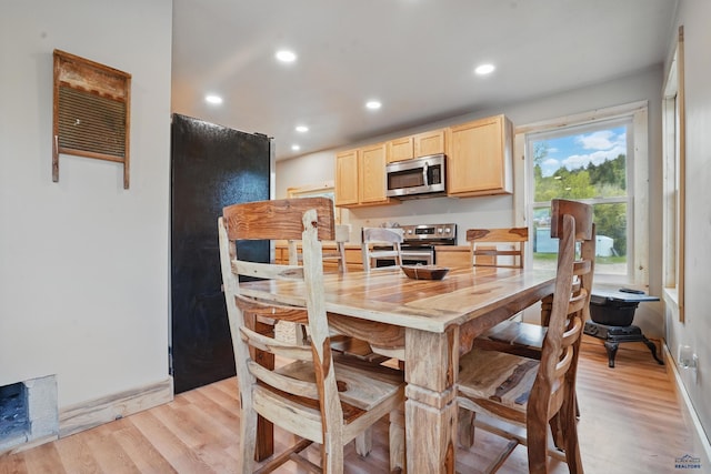 385 15th St, Sturgis, SD 57785 - kitchen with light brown cabinetry, stainless steel appliances, baseboards, light wood-style floors, and recessed lighting