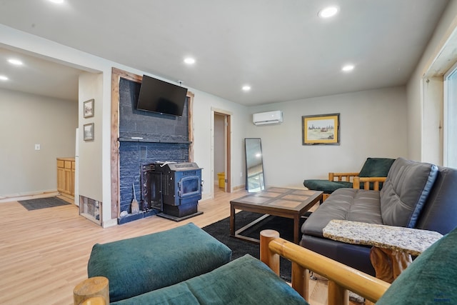 385 15th St, Sturgis, SD 57785 - living room with a wall mounted air conditioner, a wood stove, wood finished floors, recessed lighting, and baseboards