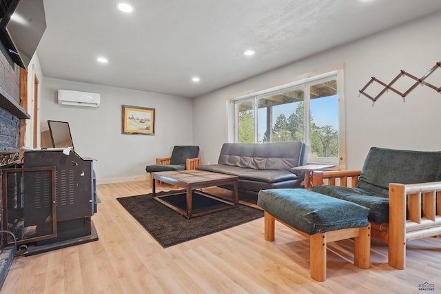 385 15th St, Sturgis, SD 57785 - living area with an AC wall unit, wood finished floors, recessed lighting, baseboards, and a stone fireplace