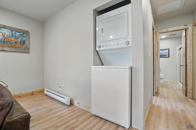385 15th St, Sturgis, SD 57785 - washroom with estacked washer and dryer, baseboard heating, light wood-type flooring, attic access, and baseboards