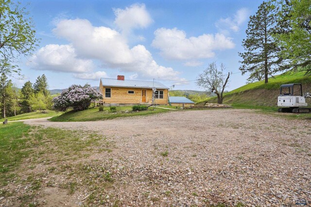 385 15th St, Sturgis, SD 57785 - back of property with a chimney and metal roof