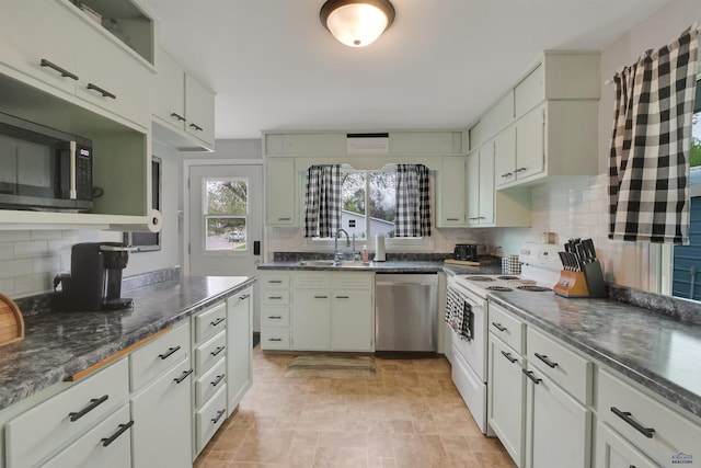 712 Stanley, Belle Fourche, SD 57717 - kitchen with stainless steel dishwasher, white range with electric cooktop, backsplash, a sink, and stone finish flooring