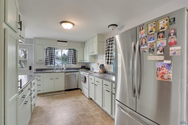 712 Stanley, Belle Fourche, SD 57717 - kitchen with stainless steel appliances, a sink, backsplash, and white cabinets