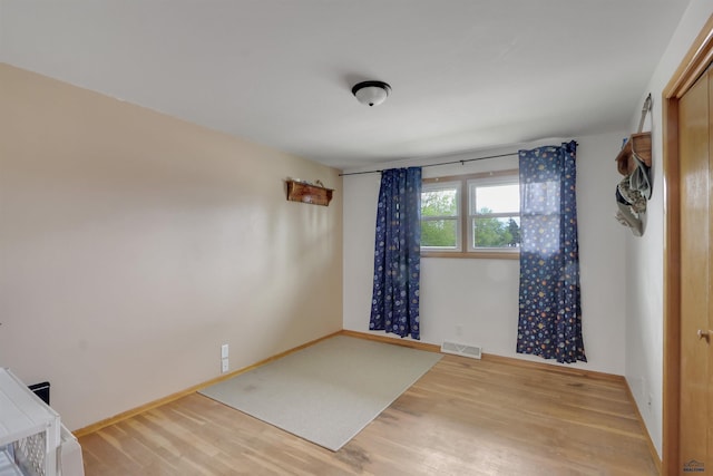 712 Stanley, Belle Fourche, SD 57717 - spare room featuring wood finished floors and baseboards