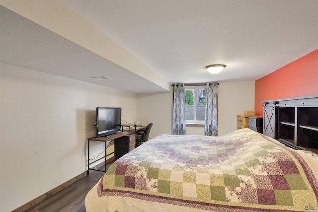 712 Stanley, Belle Fourche, SD 57717 - bedroom featuring dark wood-style floors and baseboards