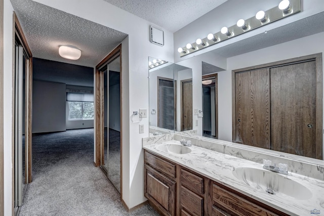 3968 Fairway Hills Dr, Rapid City, SD 57702 - bathroom featuring a textured ceiling and double vanity