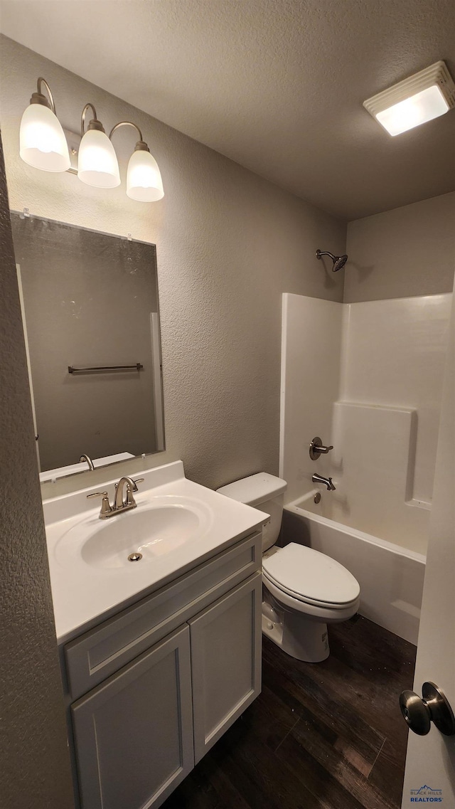 453 Yelner Dr Lot 14Blk 5, Box Elder, SD 57719 - bathroom featuring wood finished floors, vanity, toilet, tub / shower combination, and a textured wall