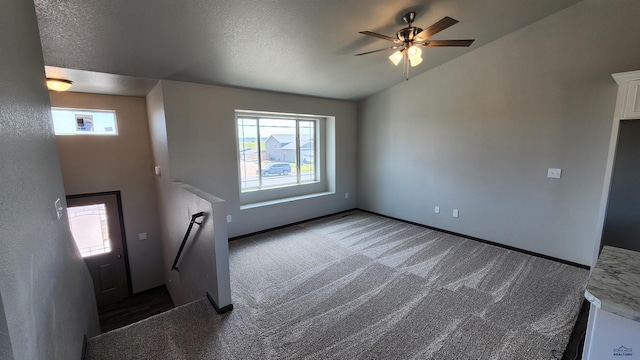 453 Yelner Dr Lot 14Blk 5, Box Elder, SD 57719 - unfurnished living room with vaulted ceiling, a ceiling fan, carpet floors, and baseboards