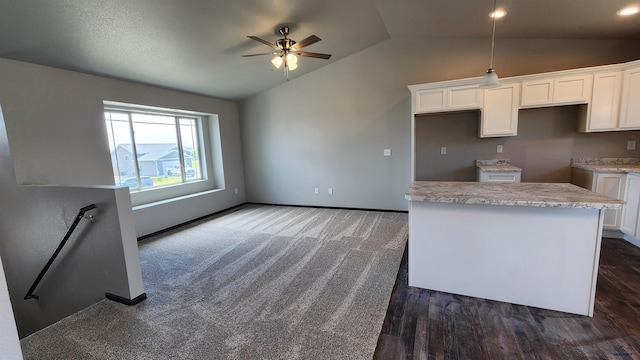 453 Yelner Dr Lot 14Blk 5, Box Elder, SD 57719 - kitchen featuring vaulted ceiling, white cabinets, ceiling fan, a center island, and baseboards