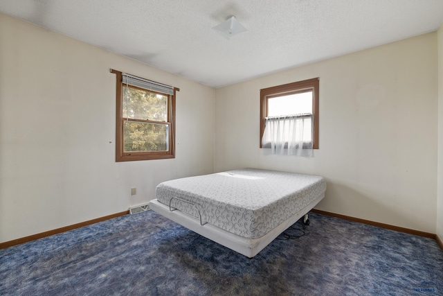 6312 Fairway Dr, Black Hawk, SD 57718 - carpeted bedroom featuring baseboards and a textured ceiling