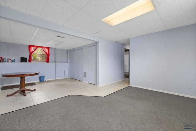 6312 Fairway Dr, Black Hawk, SD 57718 - below grade area featuring a drop ceiling, carpet flooring, tile patterned flooring, and baseboards