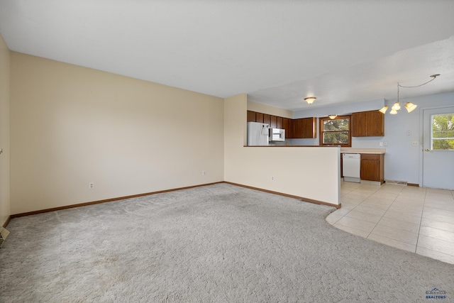 6312 Fairway Dr, Black Hawk, SD 57718 - unfurnished living room with light colored carpet, baseboards, and a chandelier