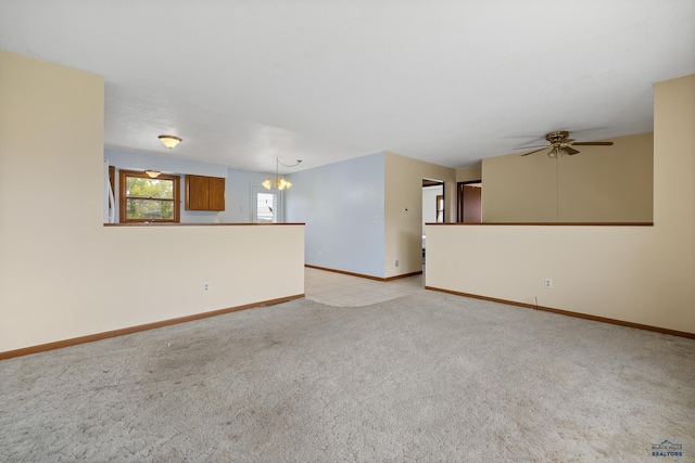 6312 Fairway Dr, Black Hawk, SD 57718 - unfurnished living room featuring light carpet, a chandelier, baseboards, and ceiling fan