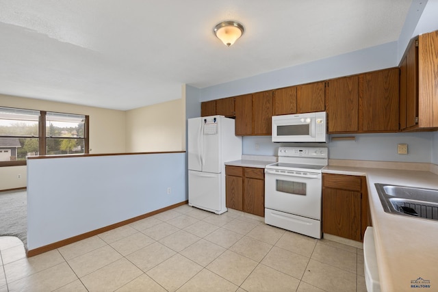 6312 Fairway Dr, Black Hawk, SD 57718 - kitchen featuring white appliances, brown cabinetry, light countertops, light tile patterned floors, and a sink