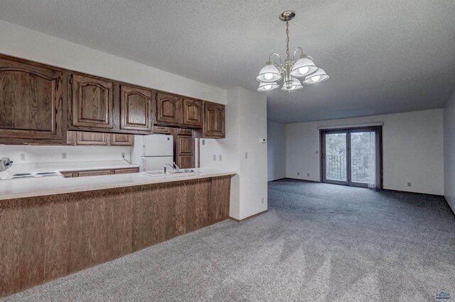 3965 Fairway Hills Dr, Rapid City, SD 57702 - kitchen featuring light colored carpet, a chandelier, white appliances, light countertops, and a sink