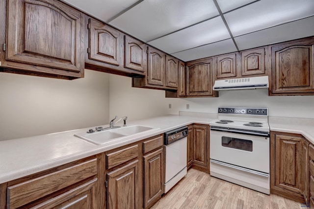 3965 Fairway Hills Dr, Rapid City, SD 57702 - kitchen featuring white appliances, range hood, a sink, light wood-type flooring, and light countertops