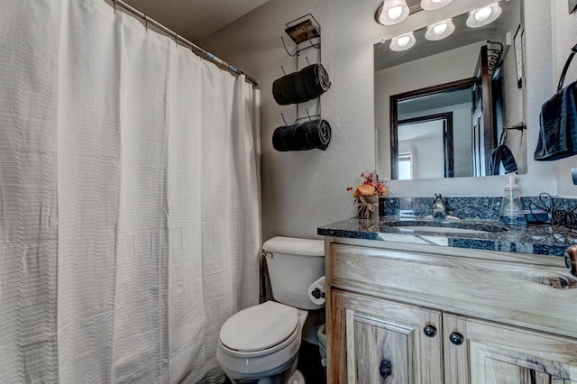 22970 Candlelight Dr, Rapid City, SD 57703 - bathroom featuring a textured wall, toilet, and vanity