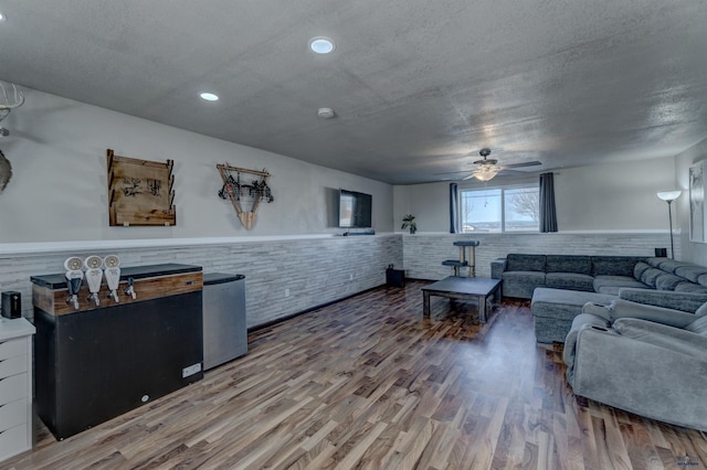 22970 Candlelight Dr, Rapid City, SD 57703 - living room featuring a wainscoted wall, a ceiling fan, wood finished floors, recessed lighting, and a textured ceiling