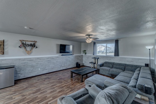 22970 Candlelight Dr, Rapid City, SD 57703 - living area with a textured ceiling, a wainscoted wall, a ceiling fan, and wood finished floors