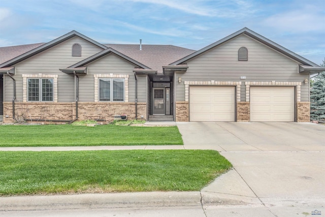 6516 Muirfield Dr, Rapid City, SD 57702 - ranch-style house featuring brick siding, concrete driveway, a garage, a front yard, and roof with shingles