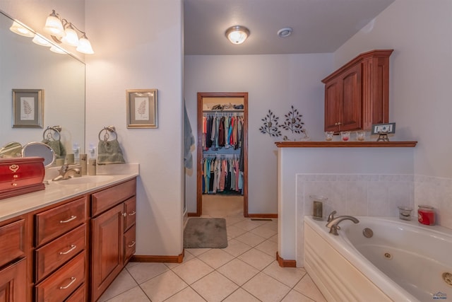 6516 Muirfield Dr, Rapid City, SD 57702 - bathroom featuring tile patterned floors, vanity, a jetted tub, baseboards, and a spacious closet