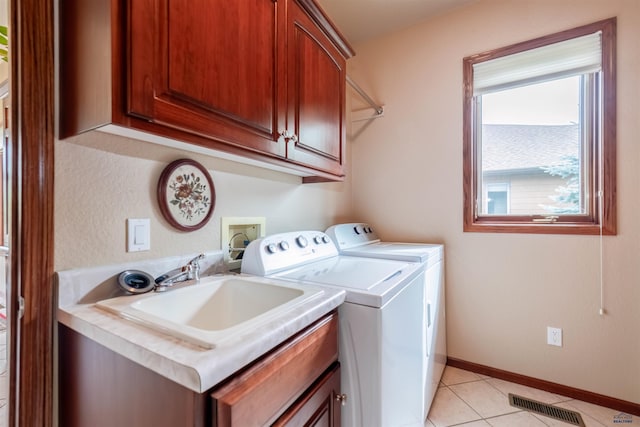 6516 Muirfield Dr, Rapid City, SD 57702 - laundry room featuring cabinet space, washing machine and clothes dryer, light tile patterned flooring, and baseboards