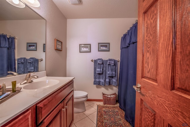 6516 Muirfield Dr, Rapid City, SD 57702 - full bathroom featuring tile patterned flooring, toilet, vanity, and baseboards