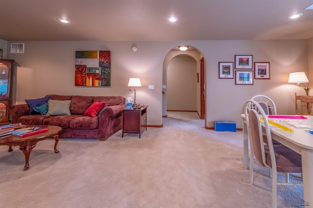 6516 Muirfield Dr, Rapid City, SD 57702 - living room featuring arched walkways, light carpet, recessed lighting, and baseboards