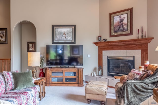 6516 Muirfield Dr, Rapid City, SD 57702 - living area featuring carpet flooring, arched walkways, and a fireplace