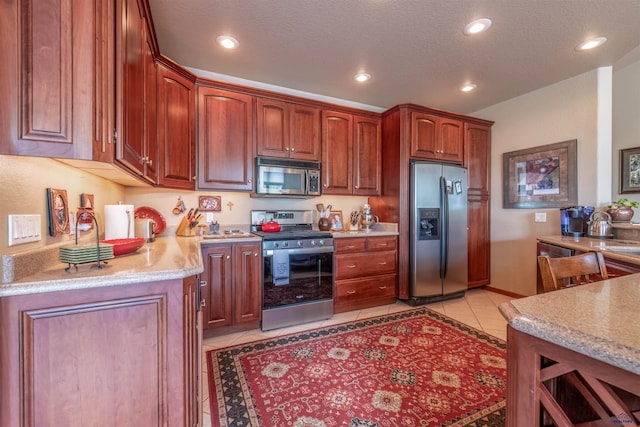 6516 Muirfield Dr, Rapid City, SD 57702 - kitchen featuring stainless steel appliances, light tile patterned flooring, recessed lighting, and a textured ceiling