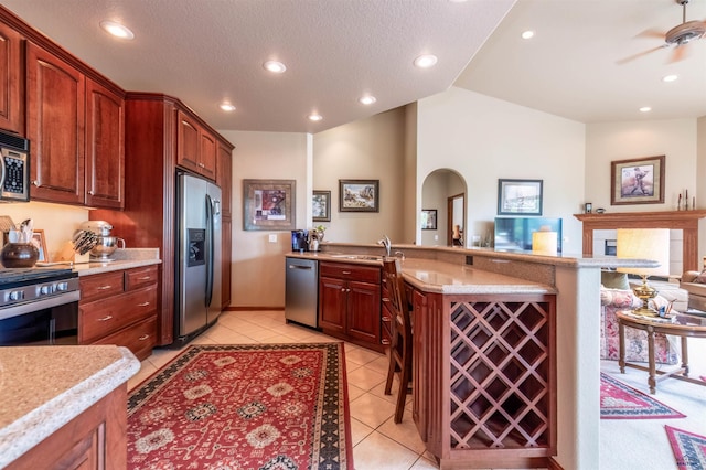 6516 Muirfield Dr, Rapid City, SD 57702 - kitchen featuring appliances with stainless steel finishes, light countertops, open floor plan, light tile patterned floors, and recessed lighting