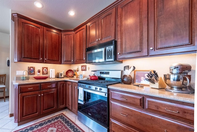 6516 Muirfield Dr, Rapid City, SD 57702 - kitchen with appliances with stainless steel finishes, light tile patterned flooring, light stone counters, and recessed lighting