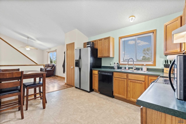 5436 Weathervane Ln, Rapid City, SD 57703 - kitchen with black dishwasher, stainless steel fridge, a sink, dark countertops, and open floor plan