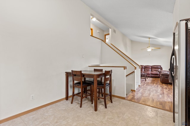 5436 Weathervane Ln, Rapid City, SD 57703 - dining space with vaulted ceiling, ceiling fan, stairway, and baseboards