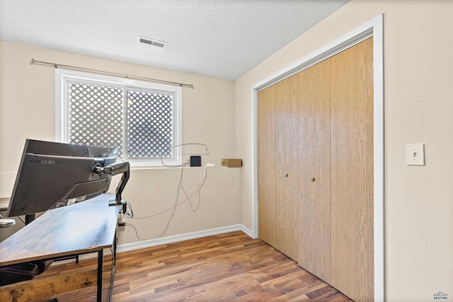 5436 Weathervane Ln, Rapid City, SD 57703 - home office with wood finished floors, a textured ceiling, and baseboards