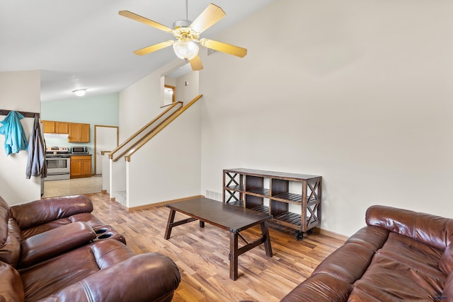 5436 Weathervane Ln, Rapid City, SD 57703 - living area featuring vaulted ceiling, light wood-type flooring, baseboards, a ceiling fan, and stairs