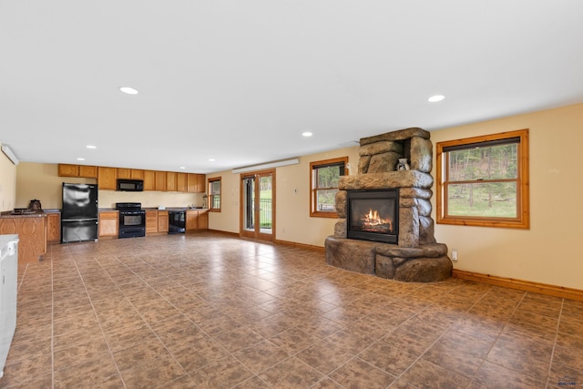 22600 Jenny Gulch Rd Unit 22600/22636Jenny, Gulch Rd, Rapid City, SD 57702 - unfurnished living room featuring a stone fireplace, baseboards, and recessed lighting