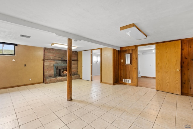 22600 Jenny Gulch Rd Unit 22600/22636Jenny, Gulch Rd, Rapid City, SD 57702 - below grade area with wooden walls, baseboards, a brick fireplace, and light tile patterned flooring