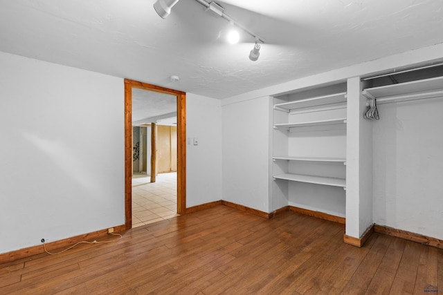 22600 Jenny Gulch Rd Unit 22600/22636Jenny, Gulch Rd, Rapid City, SD 57702 - unfurnished bedroom with wood-type flooring, baseboards, and rail lighting